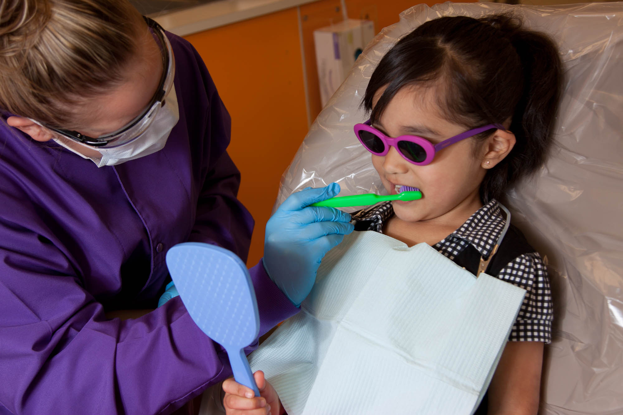 Dental student working with a young patient
